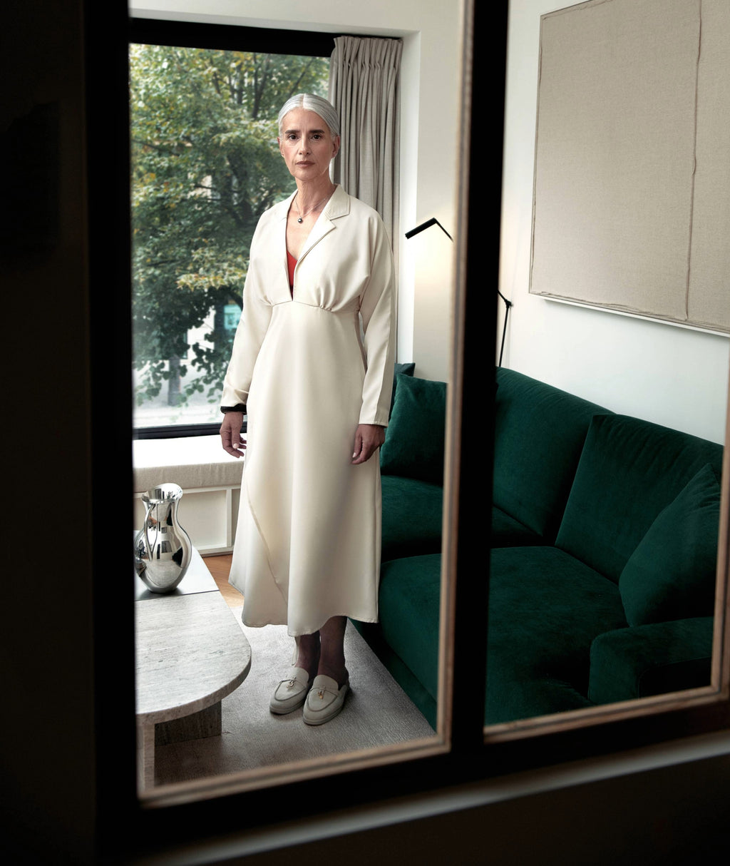 Front full look of Drift Midi Dress by IKKHO in soft ivory, a collared V neck long sleeve midi dress with fluid drape