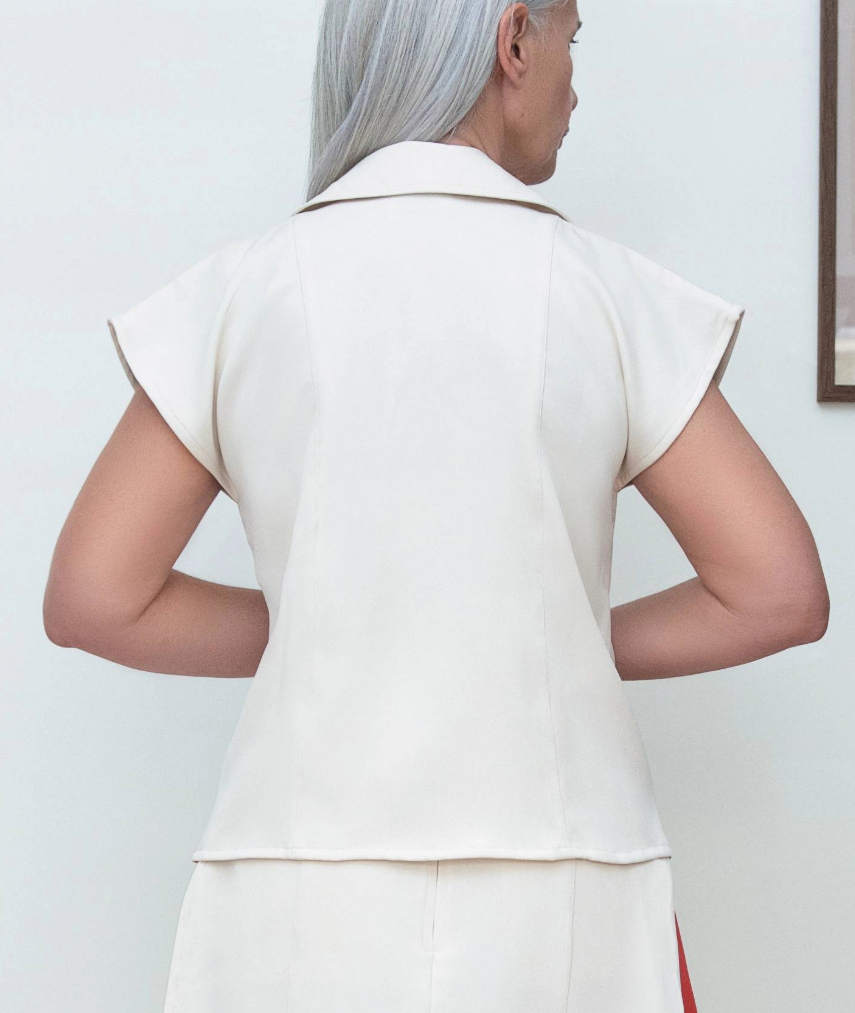 Back view of Edge Double Collared Top by IKKHO showing tailored shaping and clean silhouette with cap sleeves